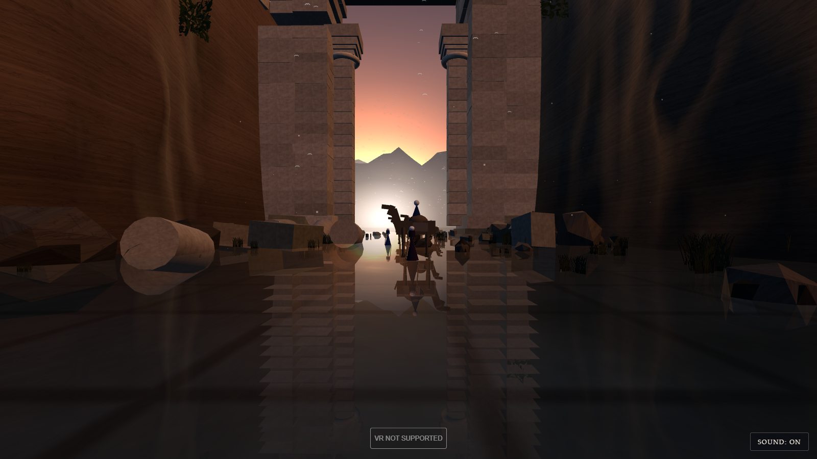 Closer to the gate. Two tall stone piers built from individual blocks frame the opening, each with a round column set into its inner edge. Through the opening the sun is low behind a mountain ridge. A camel with a rider and two robed figures wade through the doorway, black against the light, their reflections running down the water towards the viewer. Fallen column drums and boulders lie on either side