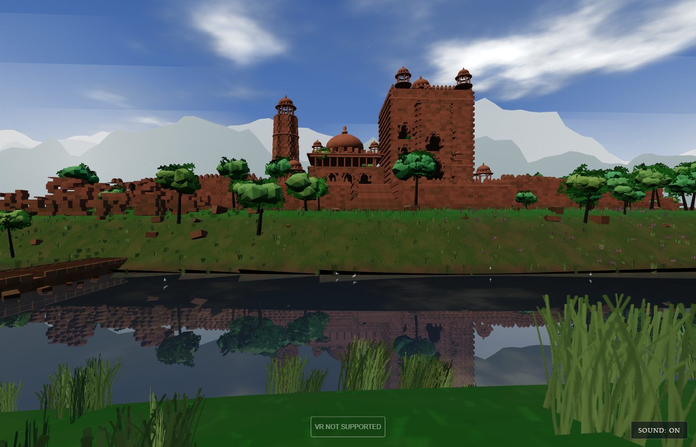 A low-polygon red sandstone palace across still water: towers with domed pavilions, a curtain wall running into trees on both sides, green mountains and a blue sky with clouds behind it, grass and reeds in the foreground, and the whole palace reflected in the dark lake